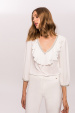 Elegant top with flounces and jewelry type applications